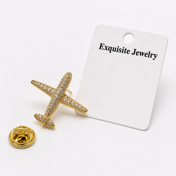 Broche déco avion avec strass imitation diamant finition dorée élégante