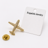 Broche déco avion avec strass imitation diamant finition dorée élégante